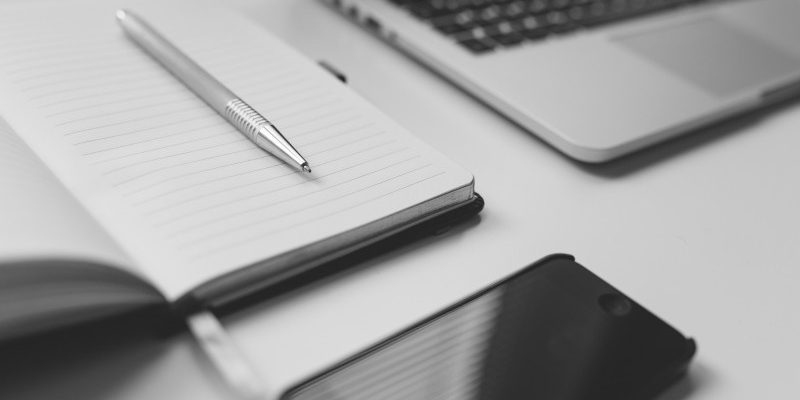 black-and-white-image-of-mobile-phone-and-notebook